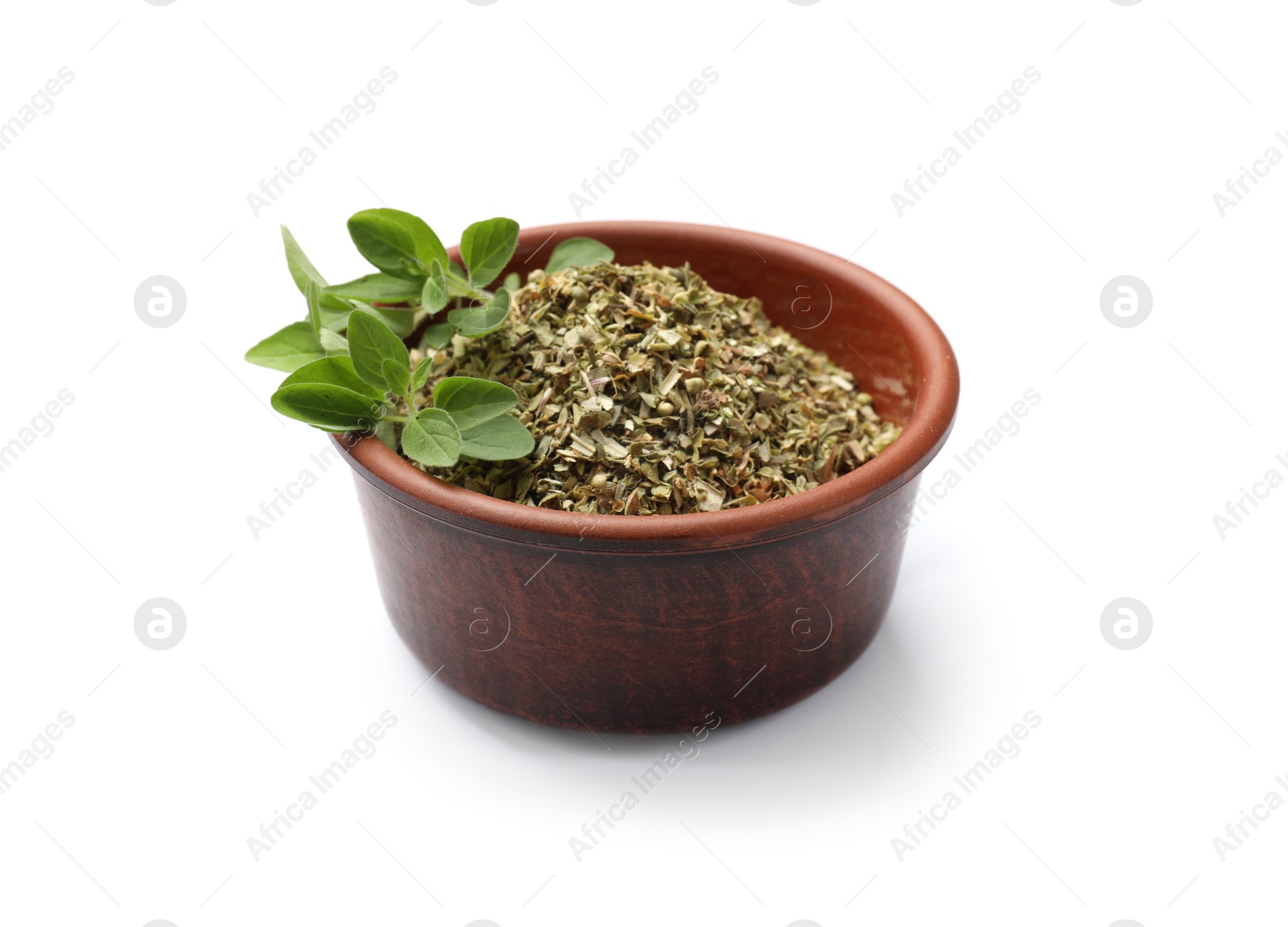 Photo of Dried oregano in bowl and green leaves isolated on white