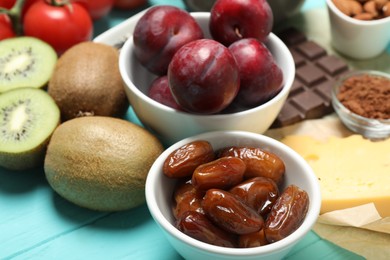 Photo of Different products rich in serotonin on light blue wooden table, closeup