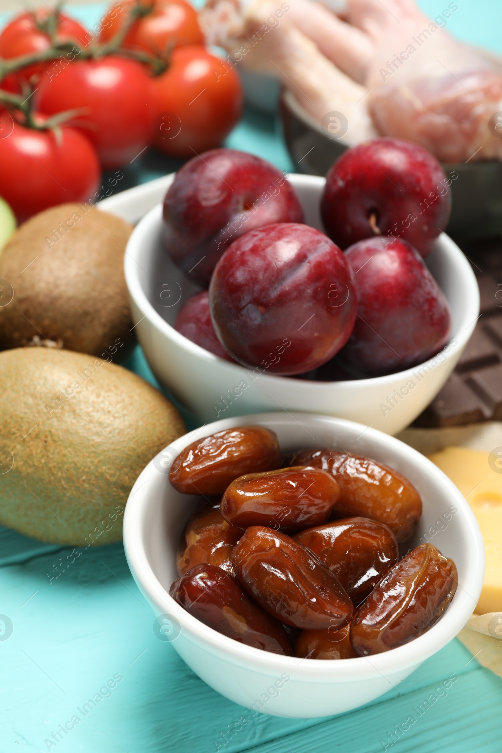 Photo of Different products rich in serotonin on light blue wooden table, closeup