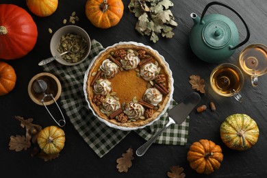 Flat lay composition with homemade pumpkin pie on black table