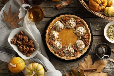 Flat lay composition with homemade pumpkin pie on wooden table