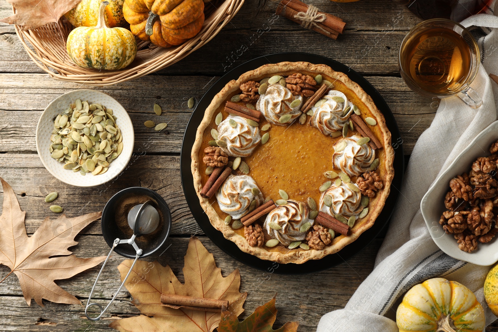 Photo of Flat lay composition with homemade pumpkin pie on wooden table