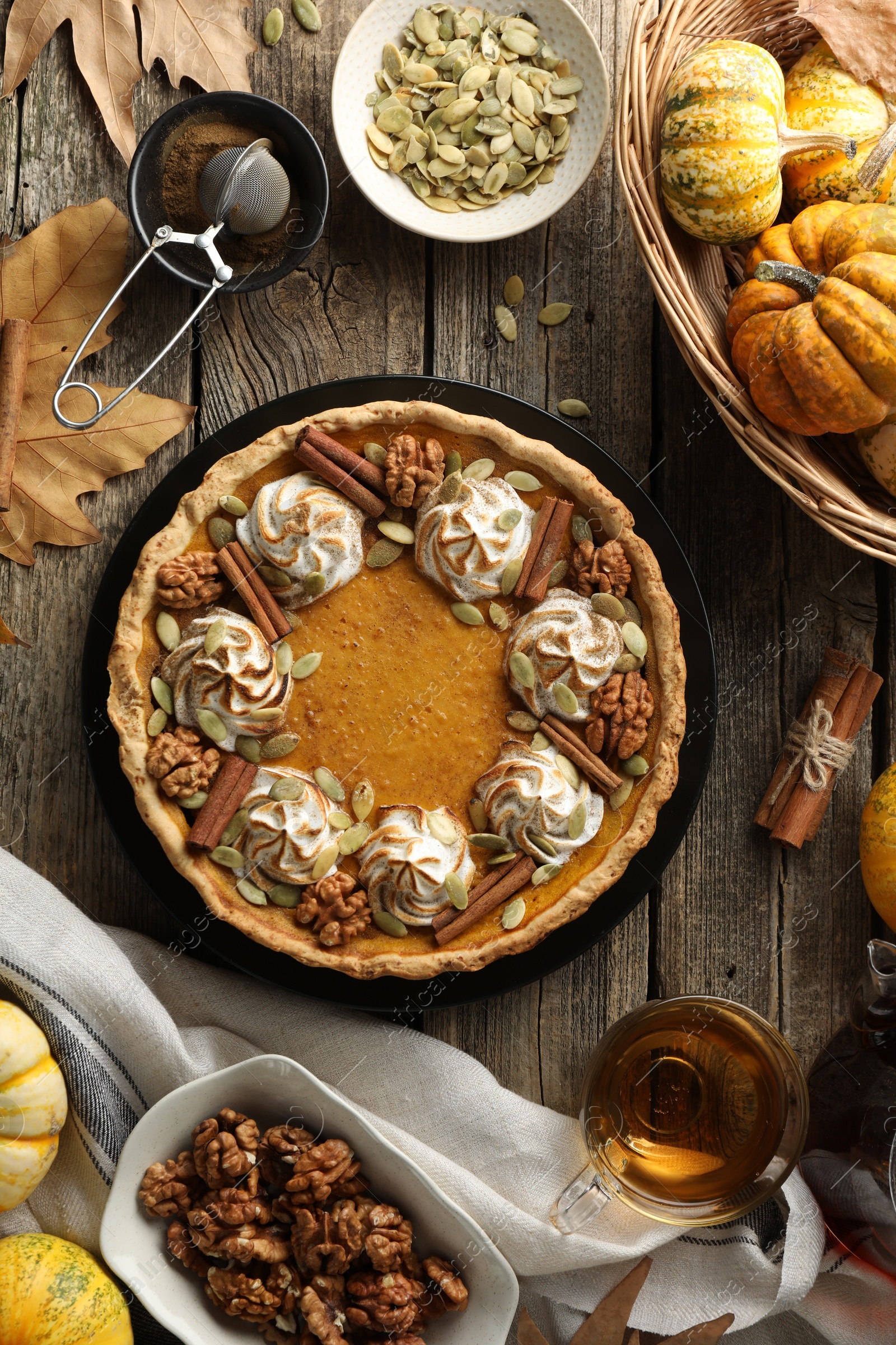 Photo of Flat lay composition with homemade pumpkin pie on wooden table