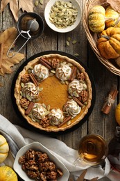 Photo of Flat lay composition with homemade pumpkin pie on wooden table