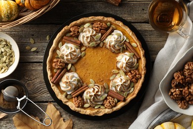 Photo of Flat lay composition with homemade pumpkin pie on wooden table