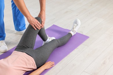 Physiotherapist working with patient in rehabilitation center, closeup