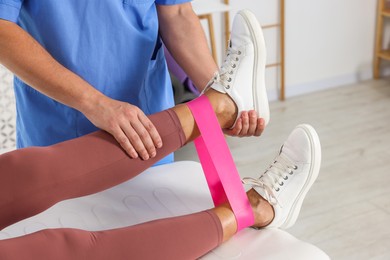 Photo of Physiotherapist working with senior patient in rehabilitation center, closeup