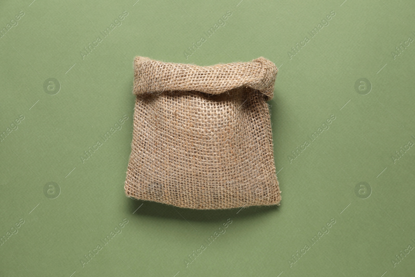 Photo of One burlap sack on olive background, top view