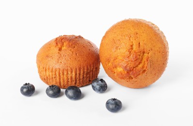 Photo of Delicious sweet muffins and blueberries isolated on white