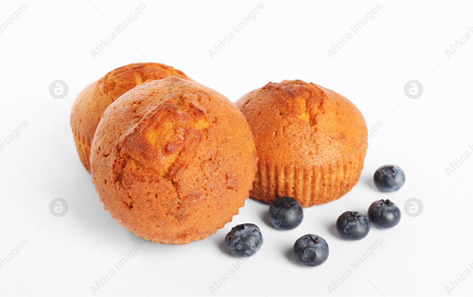 Photo of Delicious sweet muffins and blueberries isolated on white