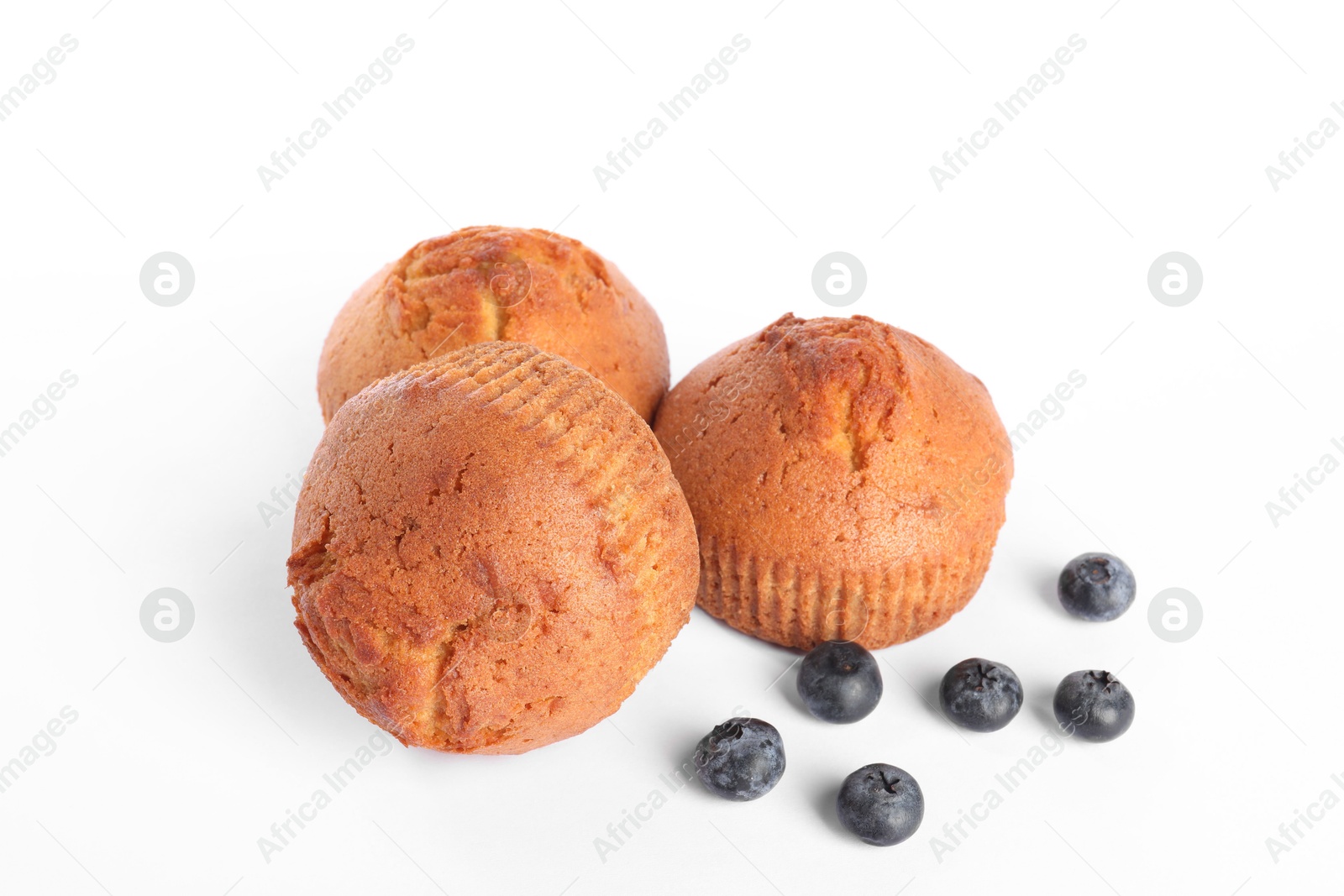 Photo of Delicious sweet muffins and blueberries isolated on white