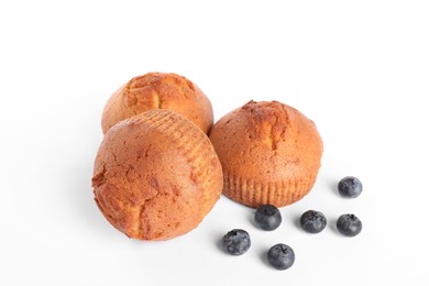 Photo of Delicious sweet muffins and blueberries isolated on white