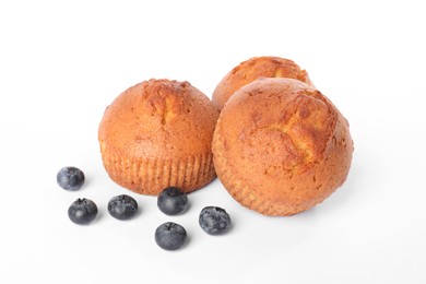 Photo of Delicious sweet muffins and blueberries isolated on white