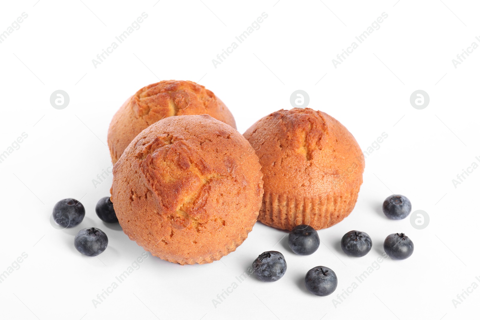 Photo of Delicious sweet muffins and blueberries isolated on white