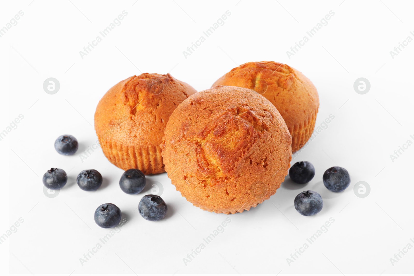 Photo of Delicious sweet muffins and blueberries isolated on white