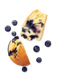 Photo of Pieces of delicious sweet muffin and blueberries isolated on white, top view