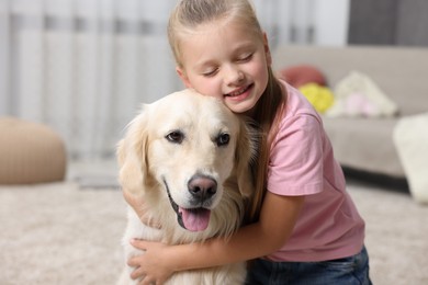 Photo of Girl with her cute Golden Retriever dog at home