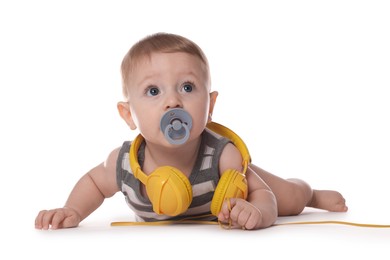 Photo of Cute little baby with pacifier and headphones on white background