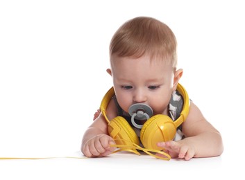 Photo of Cute little baby with pacifier and headphones on white background