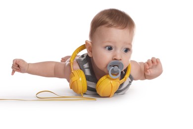 Cute little baby with pacifier and headphones on white background