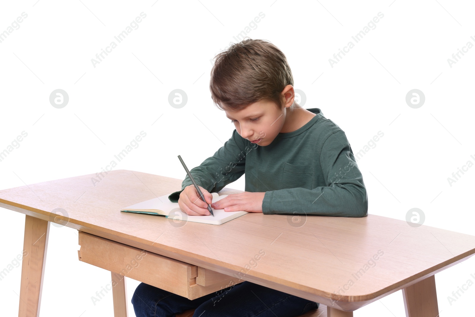 Photo of Boy with incorrect posture and notebook at wooden desk on white background