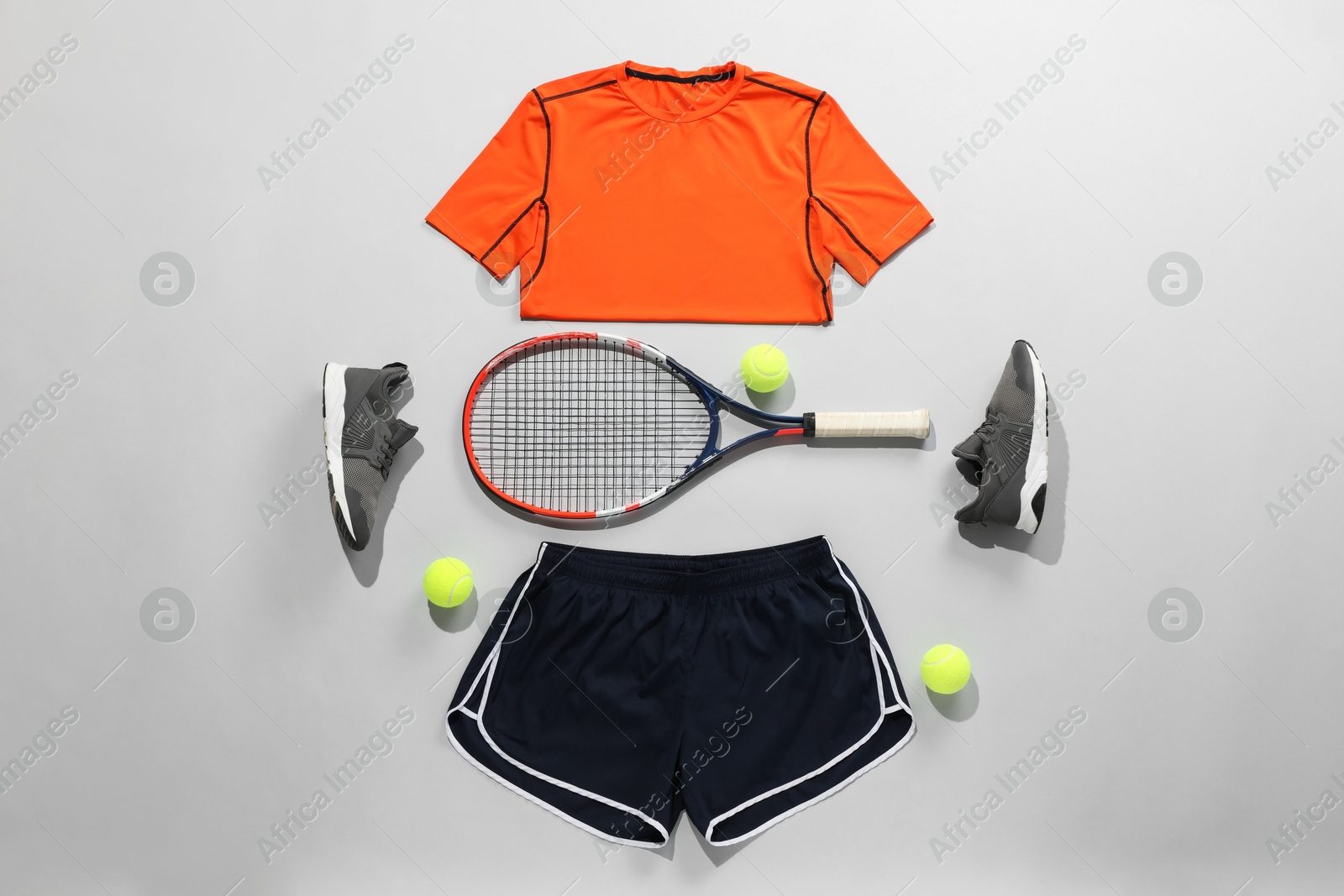 Photo of Flat lay composition with tennis racket and balls on grey background