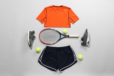 Photo of Flat lay composition with tennis racket and balls on grey background