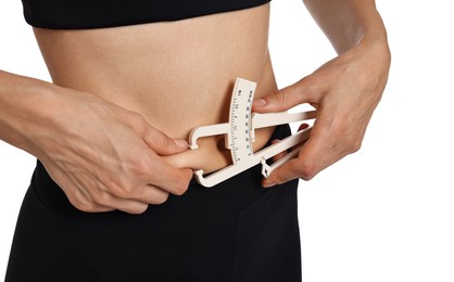 Photo of Woman measuring body fat with caliper on white background, closeup