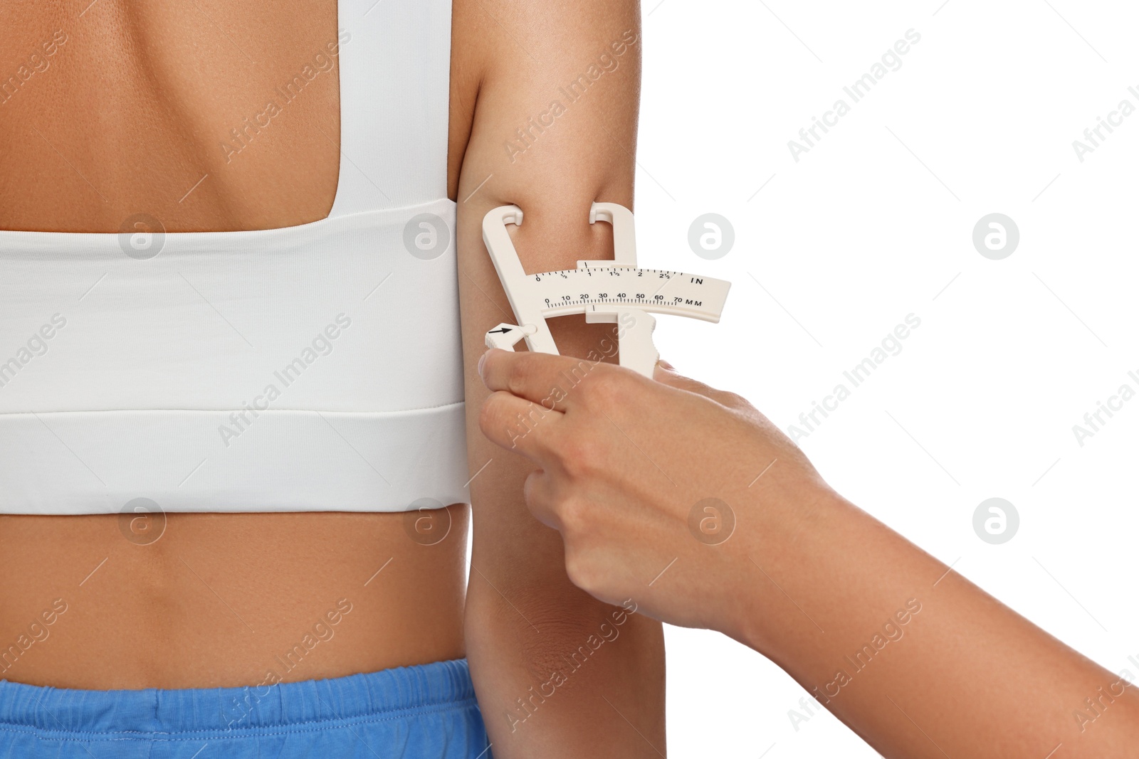 Photo of Nutritionist measuring woman's body fat with caliper on white background, closeup