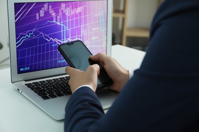 Photo of Businesswoman using smartphone at white table indoors, closeup. Modern technology