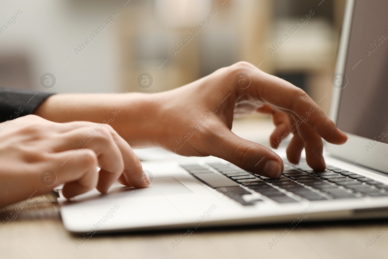 Photo of Businessman using laptop at table, closeup. Modern technology