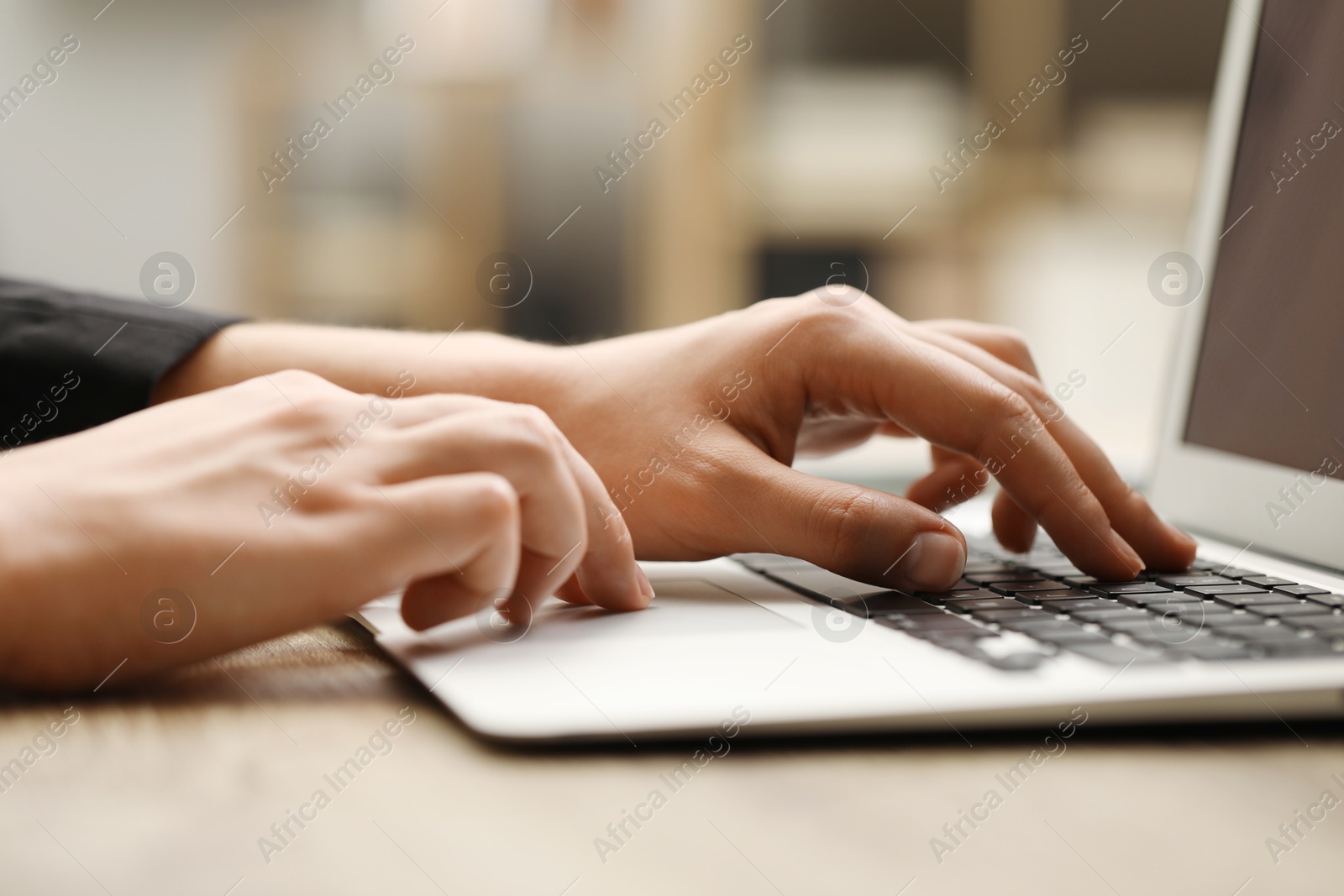 Photo of Businessman using laptop at table, closeup. Modern technology