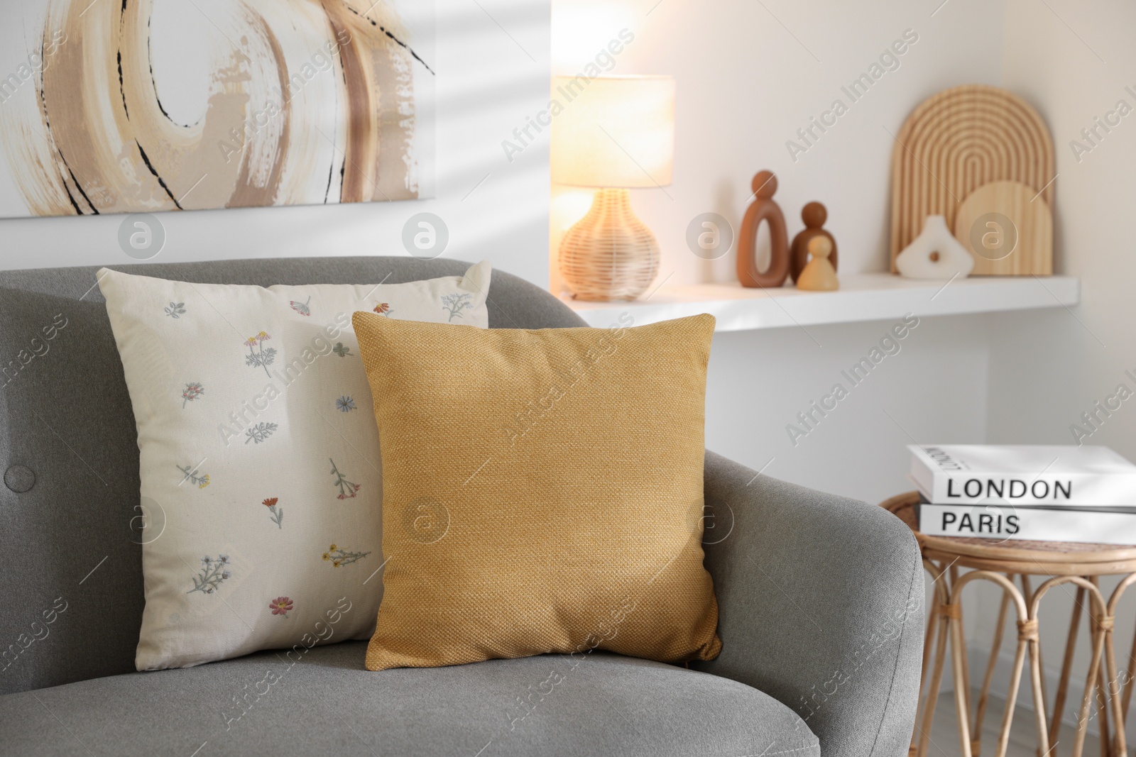 Photo of Different soft pillows on gray sofa in living room