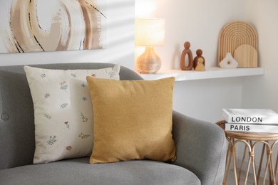 Photo of Different soft pillows on gray sofa in living room