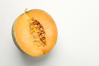 Half of fresh Cantaloupe melon on white table, top view. Space for text