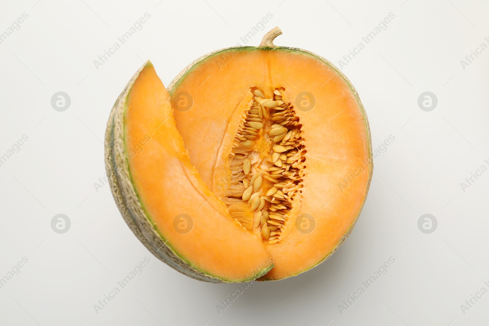 Photo of Pieces of fresh Cantaloupe melon on white table, top view