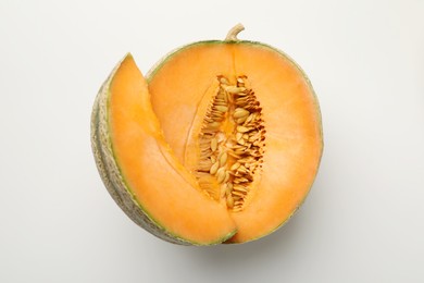 Pieces of fresh Cantaloupe melon on white table, top view