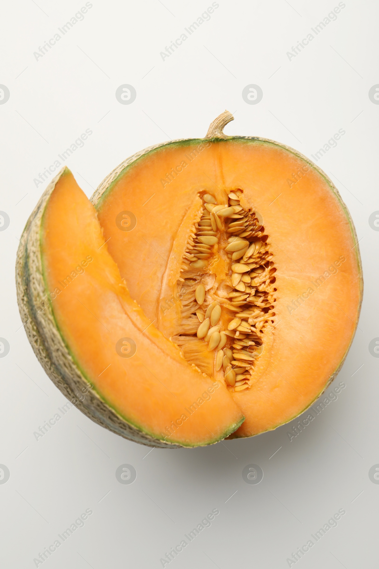 Photo of Pieces of fresh Cantaloupe melon on white table, top view