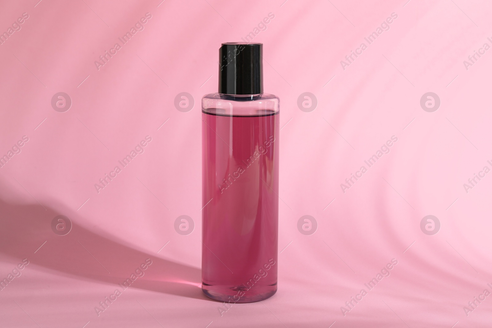 Photo of One shampoo in bottle on pink background