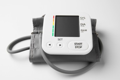 Photo of Blood pressure measuring device on white background, closeup