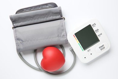 Photo of Blood pressure measuring device and squeeze heart on white background, top view