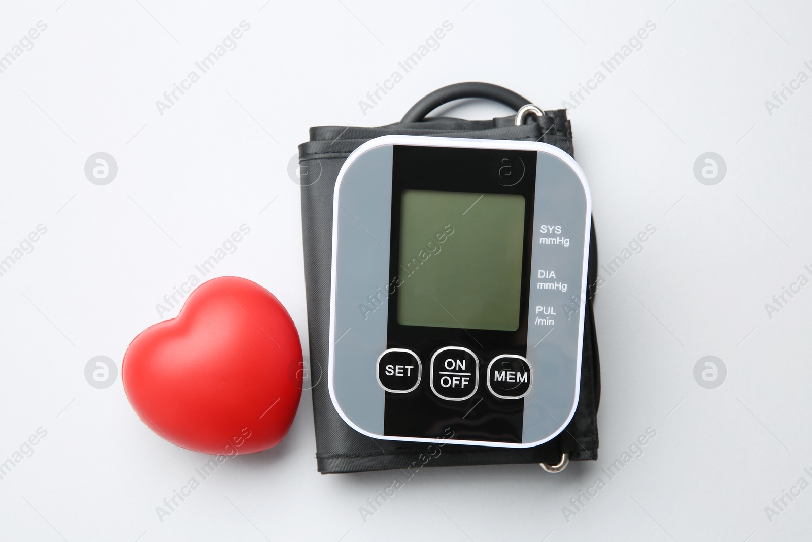 Photo of Blood pressure measuring device and squeeze heart on white background, top view