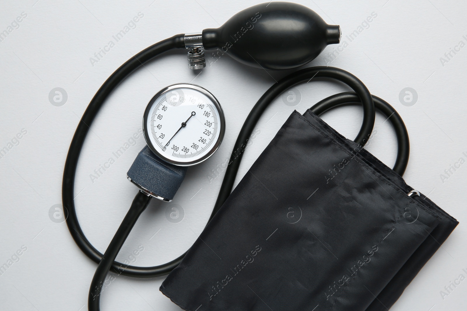 Photo of Blood pressure measuring device on light grey background, top view