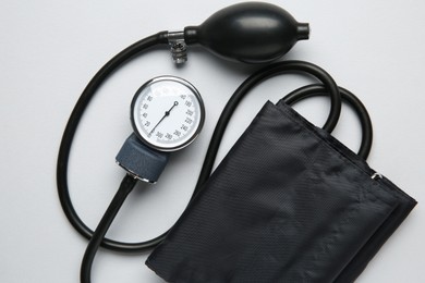 Photo of Blood pressure measuring device on light grey background, top view