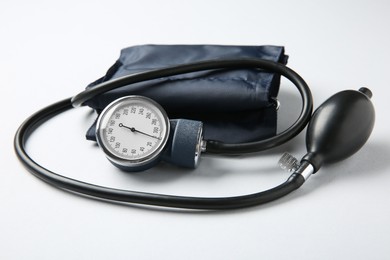 Photo of Blood pressure measuring device on white background, closeup