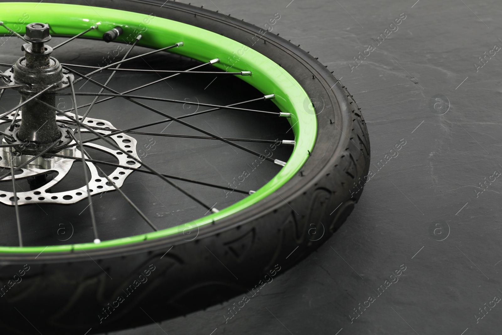 Photo of Bicycle wheel with tire on black background, closeup