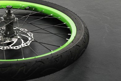 Photo of Bicycle wheel with tire on black background, closeup