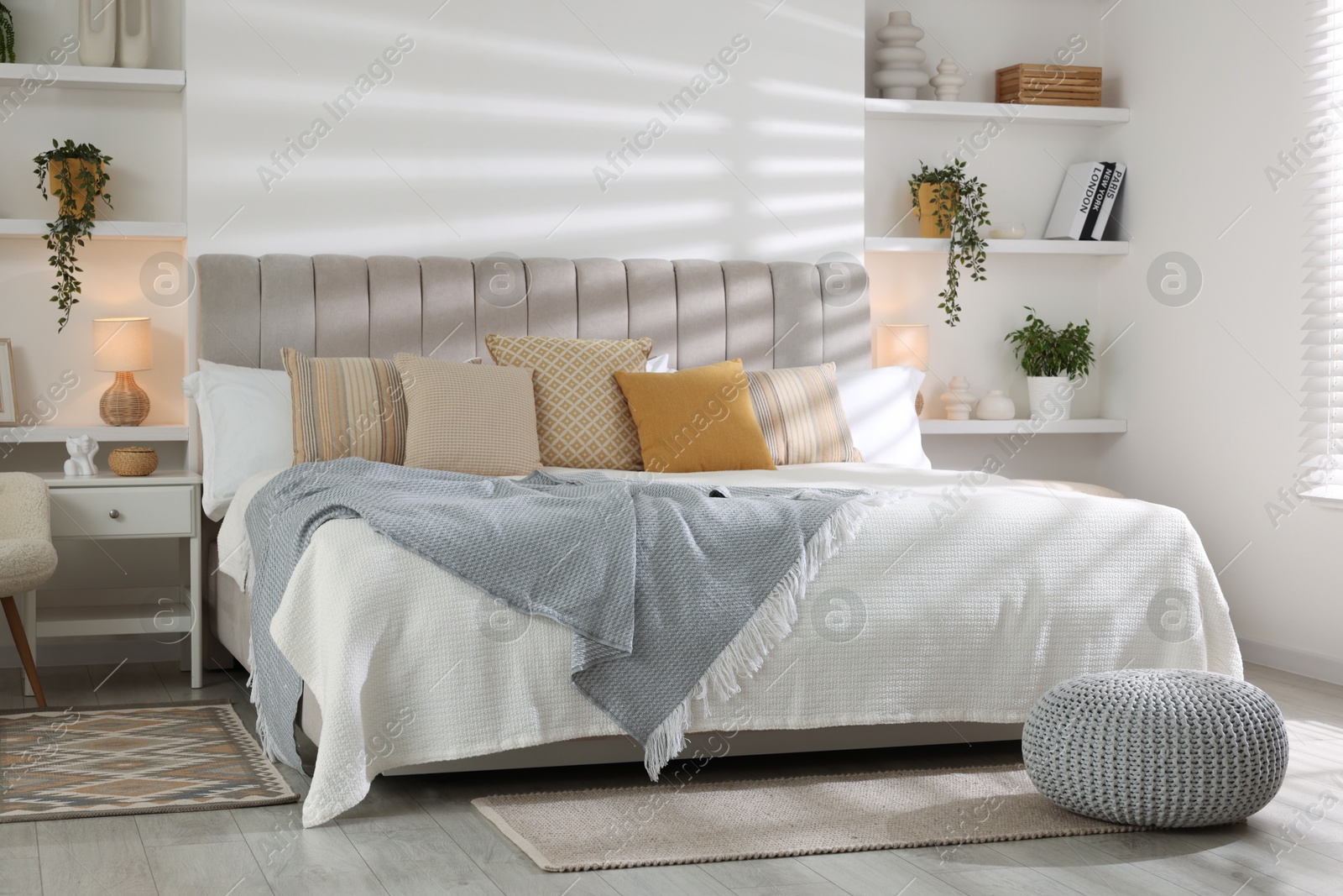 Photo of Comfortable large bed in beautiful room. Interior design