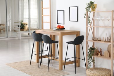 Bar stools near wooden table in room