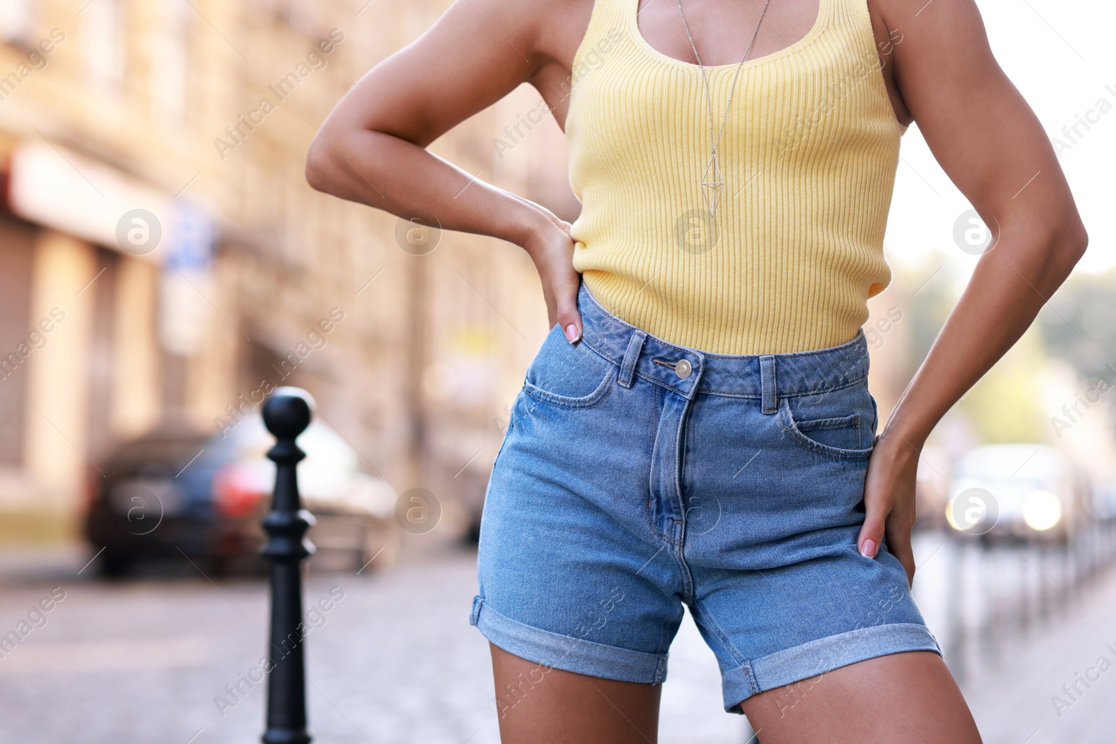 Photo of Woman wearing stylish denim shorts outdoors, closeup